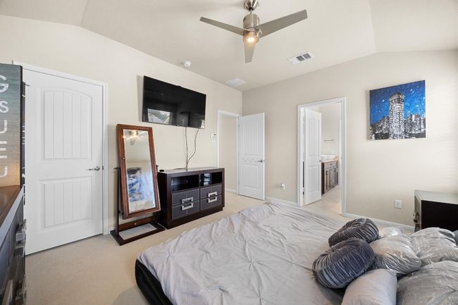 Upstairs this spacious primary suite serves as your peaceful getaway for rest and relaxation. | Image 18