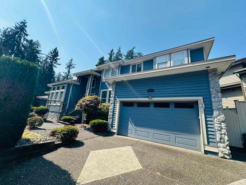 View of front of home with an attached garage and driveway | Card Image