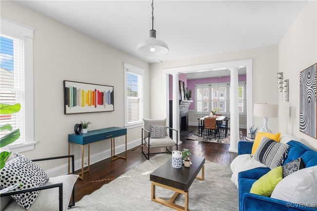 Living area with baseboards, wood finished floors, and decorative columns | Image 11