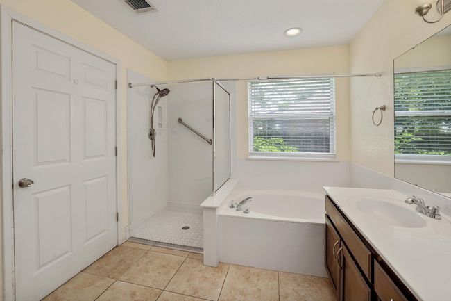 Bathroom featuring a shower stall, a bath, vanity, and tile patterned floors | Image 17