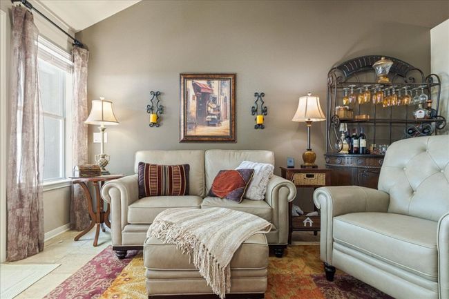 Living area featuring baseboards and vaulted ceiling | Image 15