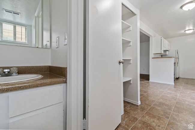 Bathroom featuring vanity and baseboards | Image 17