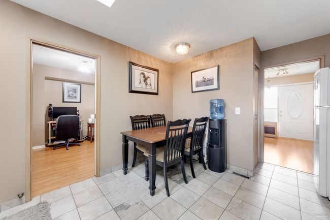 Kitchen nook area featuring light tile patterned flooring and baseboards | Image 8