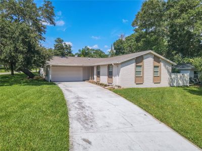 Tree Shaded, Corner lot, Three-bedroom, Two-bath, two-car garage with an updated kitchen and bathrooms. | Image 1