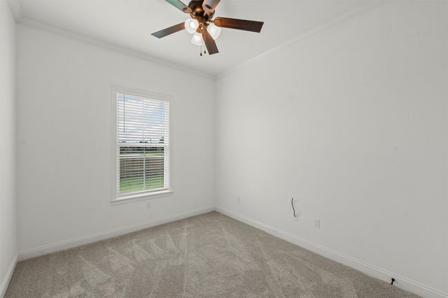 Unfurnished room featuring ornamental molding, carpet flooring, and ceiling fan | Image 13