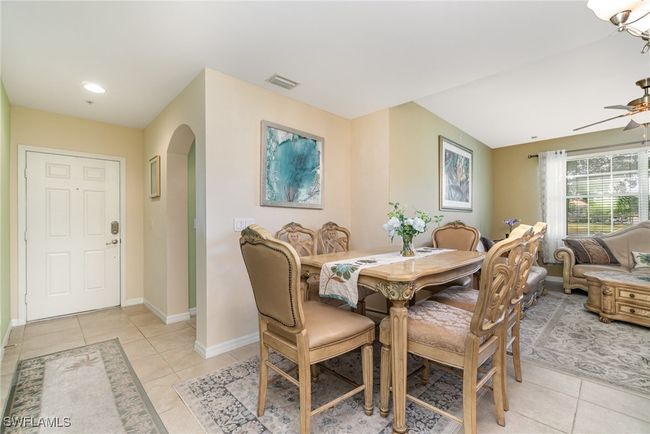 Dining space with arched walkways, light tile patterned floors, baseboards, ceiling fan, and recessed lighting | Image 4