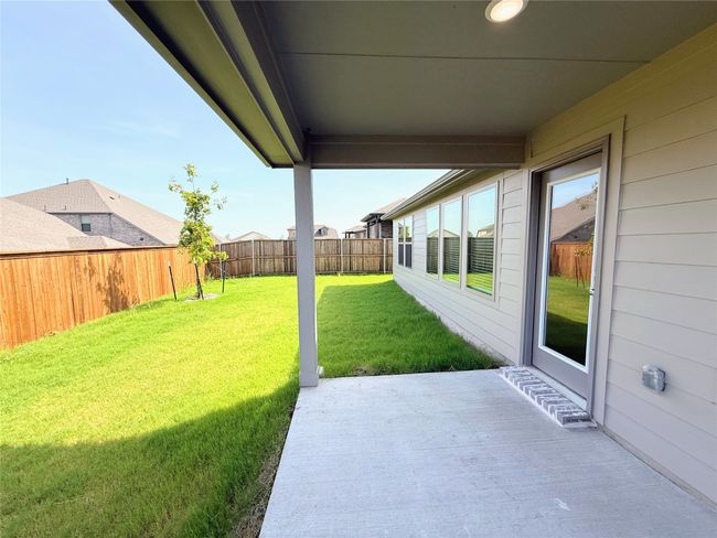 Fenced backyard with a patio area | Image 33