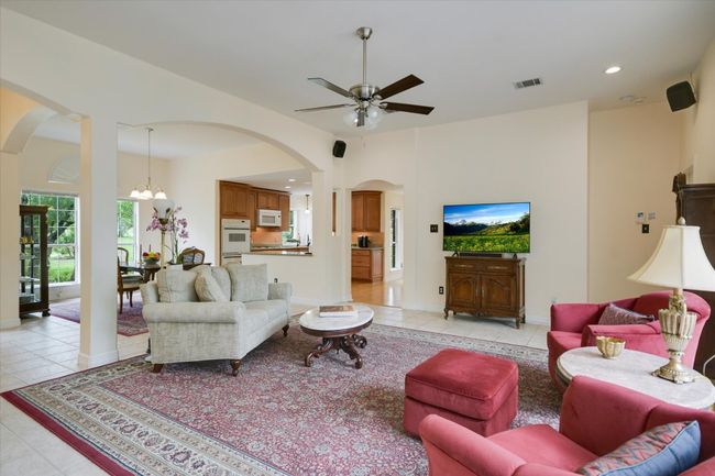 The spacious living room offers a comfortable gathering space with ample room for seating and entertaining. | Image 6