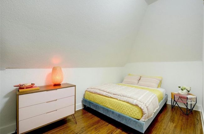Second story bedroom with wood finished floors and lofted ceiling | Image 27