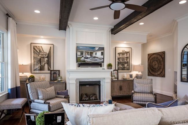 Living room with beam ceiling, a healthy amount of sunlight, hardwood / wood-style flooring, and ceiling fan | Image 5