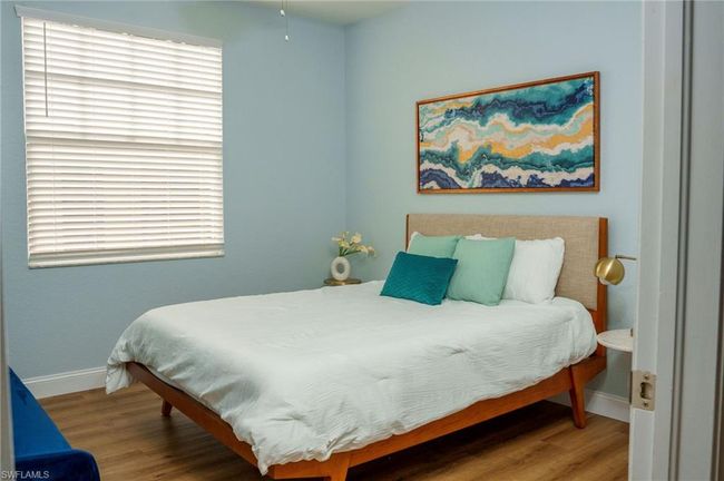 Bedroom with baseboards and wood finished floors | Image 15