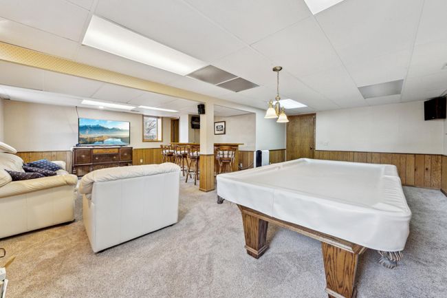 Lower level family room with a large bar | Image 16