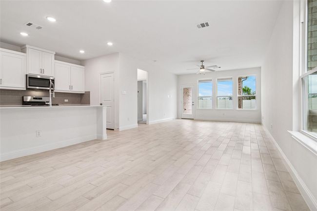 Unfurnished living room featuring light wood-type flooring, recessed lighting, and a ceiling fan | Image 28