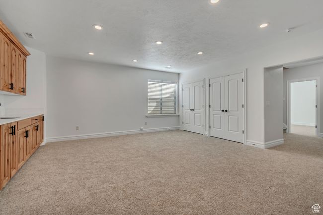 Unfurnished living room with light colored carpet and recessed lighting | Image 28