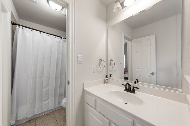 Bathroom featuring toilet, tile patterned floors, and vanity | Image 29