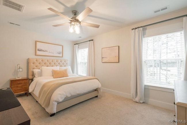 Bedroom featuring light colored carpet and a ceiling fan | Image 42