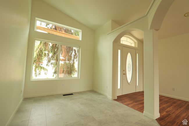 Entrance foyer featuring arched walkways and high vaulted ceiling | Image 7