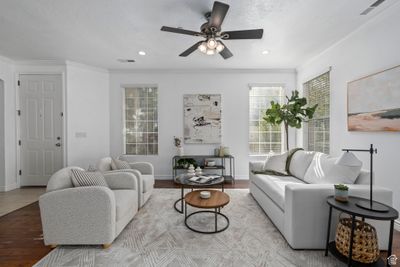 Living room featuring light hardwood / wood-style flooring, crown molding, and ceiling fan | Image 3