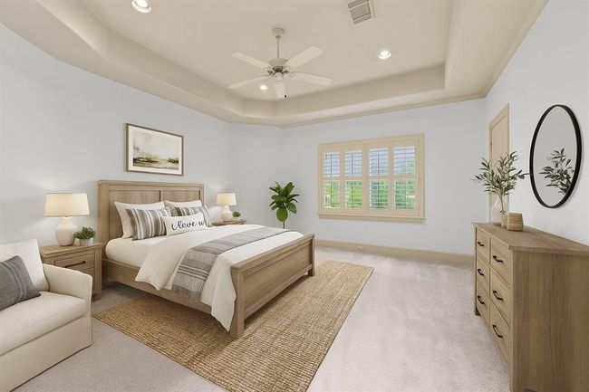 Secondary Bedroom with recently installed carpet, plantation shutters, tray ceiling w/fan, walk in closet, ensuite bathroom - virtually staged for your designing ideas. | Image 31