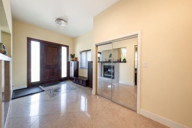 Entryway with a tiled fireplace and baseboards | Image 6