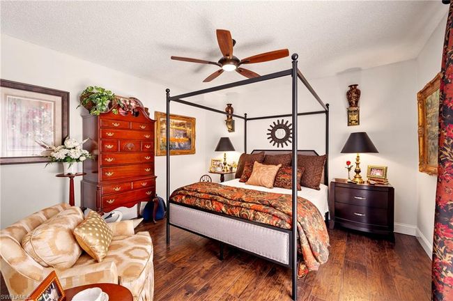 Bedroom featuring wood-type flooring, a textured ceiling, and a ceiling fan | Image 23