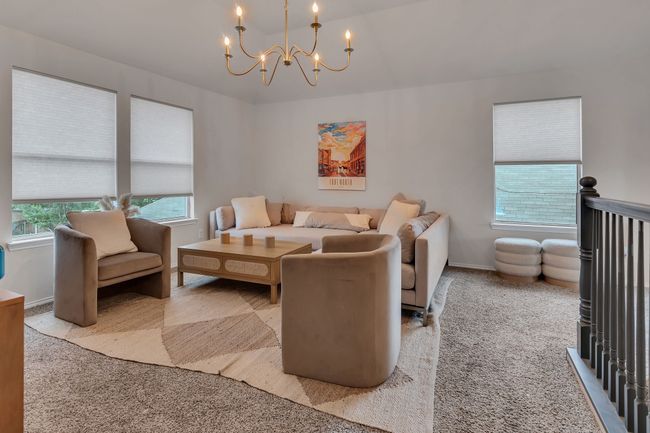 Living room with a chandelier, carpet, and baseboards | Image 20