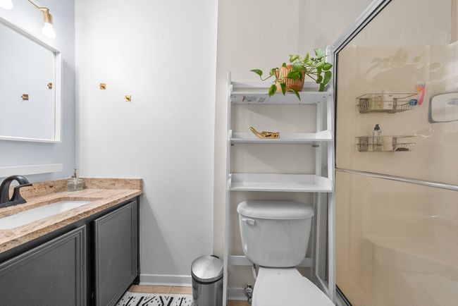 Primary Bathroom with walk in shower, Quartz Countertop Vanity and tile flooring | Image 29