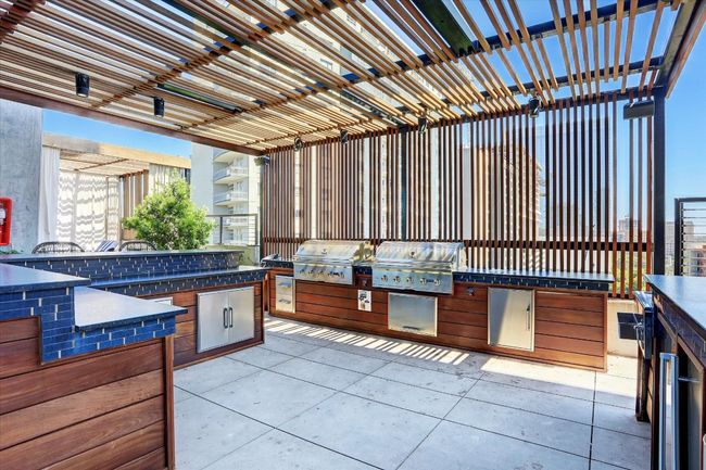 View of patio featuring area for grilling, a pergola, and an outdoor kitchen | Image 14