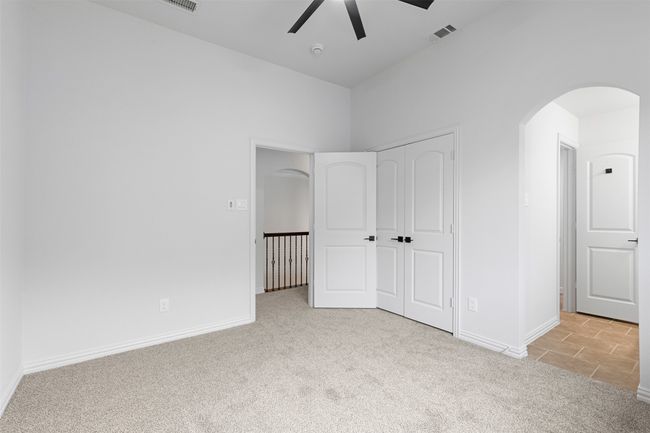 Unfurnished bedroom with arched walkways, a closet, carpet flooring, baseboards, and visible vents | Image 29
