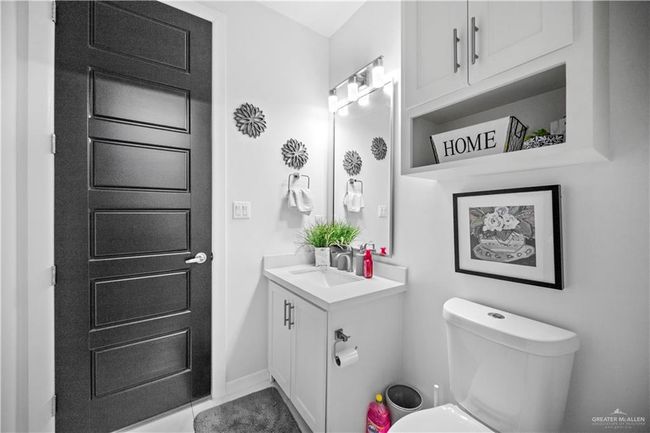 Bathroom featuring vanity, toilet, and baseboards | Image 8