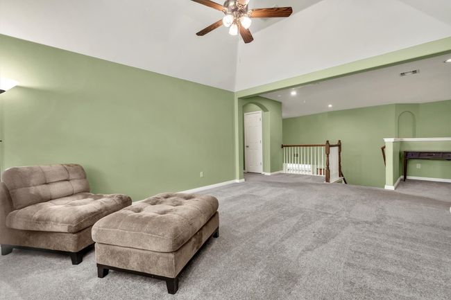 Living area featuring an upstairs landing, ceiling fan, carpet, baseboards, and visible vents | Image 22