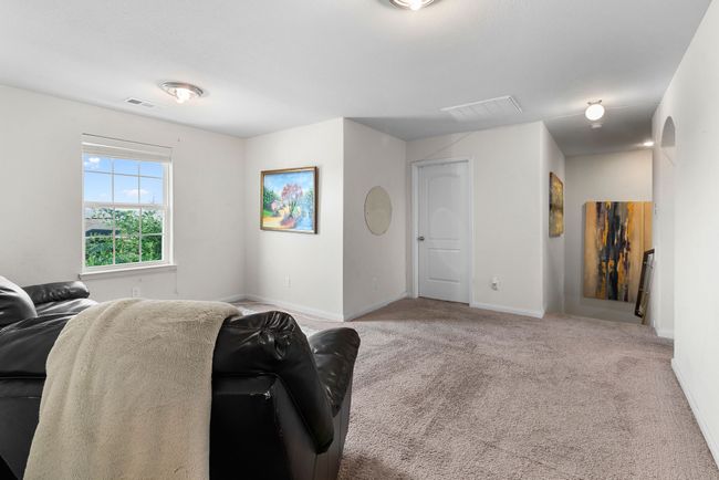 Living room with carpet floors, visible vents, and baseboards | Image 20