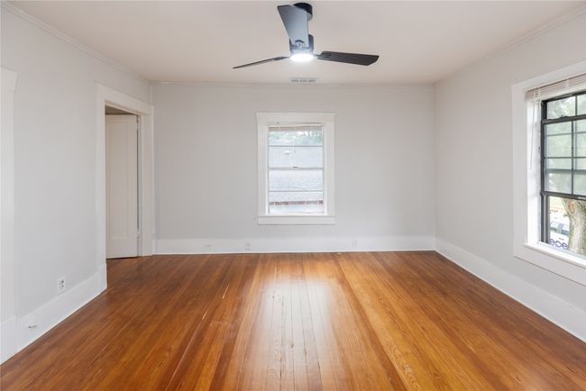 Spare room featuring wood-type flooring, a ceiling fan, ornamental molding, and baseboards | Image 20