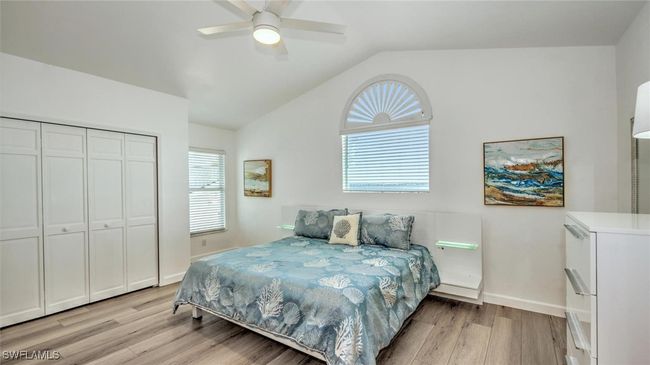 Guest Bedroom upstairs featuring light wood-type flooring, lofted ceiling, a closet, and ceiling fan | Image 24
