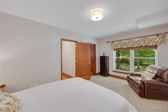 Bedroom featuring light carpet and baseboards | Image 57