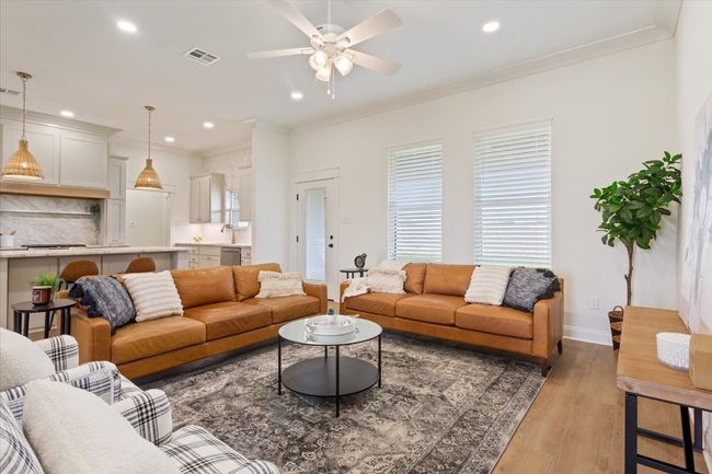 Living area with crown molding, ceiling fan, light wood-type flooring, and recessed lighting | Image 9