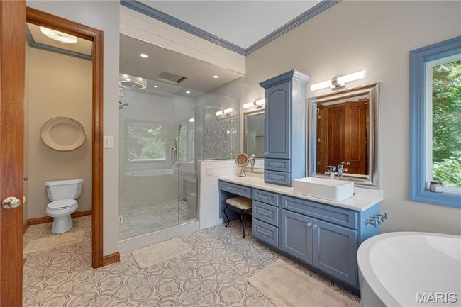Full bath with vanity, a stall shower, tile patterned floors, a freestanding bath, and ornamental molding | Image 26