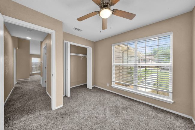 Unfurnished bedroom with carpet floors, a closet, baseboards, and visible vents | Image 16