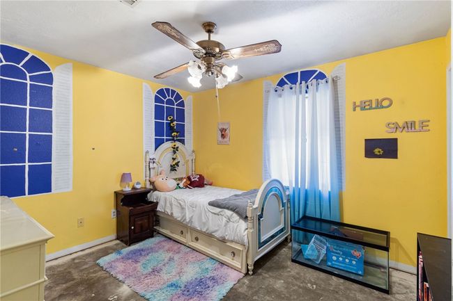 Bedroom featuring concrete flooring and ceiling fan | Image 25