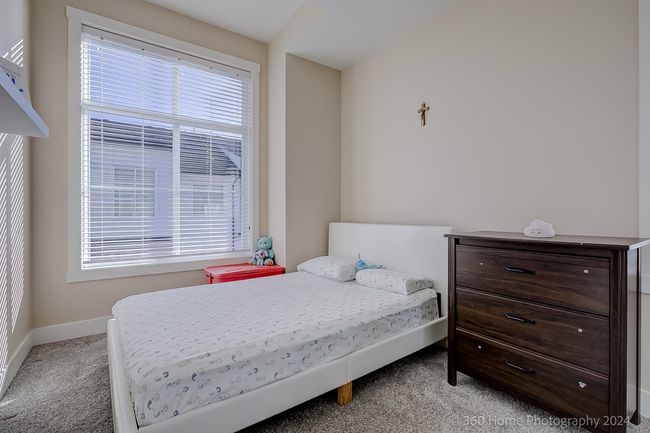 Bedroom with light carpet and baseboards | Image 10