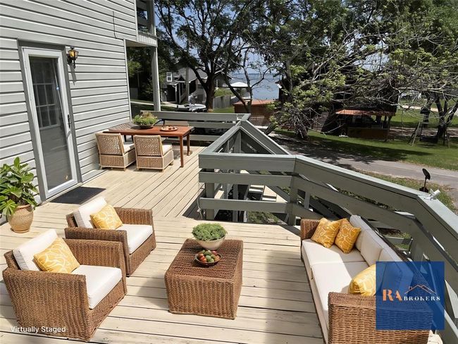 Enjoy stunning Lake Livingston views from this convenient porch right outside the kitchen—perfect for hosting cookouts with family and friends. (Virtually staged) | Image 20