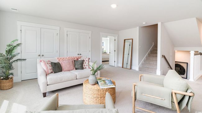 Living room featuring light carpet, baseboards, and stairs | Image 25