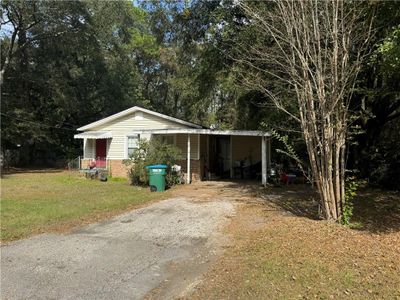 View of outdoor structure featuring a yard and a carport | Image 2