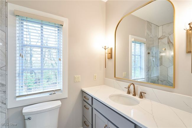Bedroom 4's bathroom has also been remodeled with new cabinet, counter top, tiled shower and flooring | Image 25