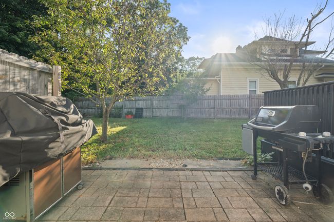fenced backyard with a patio and a grill | Image 53