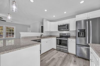 Kitchen featuring white cabinets, appliances with stainless steel finishes, and sink | Image 2