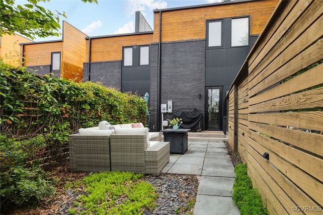 Fully fenced back yard with stamped patio, garden bed and BBQ platform. | Image 41