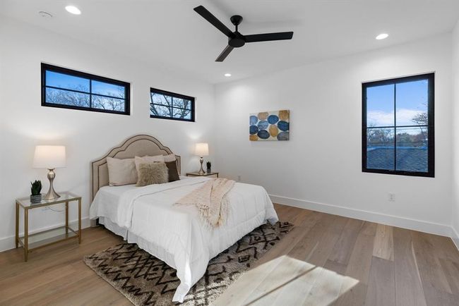 Bedroom with recessed lighting, wood finished floors, baseboards, and a ceiling fan | Image 29