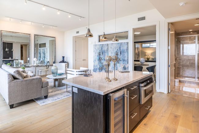 Elegant kitchen and living room combo featuring a stylish wine fridge, perfect for entertaining. | Image 16