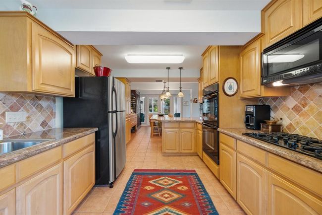 [First floor kitchen] with ample counter and storage space. | Image 27